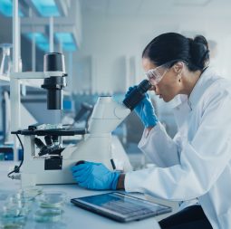 Medical,Development,Laboratory:,Caucasian,Female,Scientist,Looking,Under,Microscope,,Analyzes