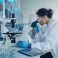 Medical,Development,Laboratory:,Caucasian,Female,Scientist,Looking,Under,Microscope,,Analyzes