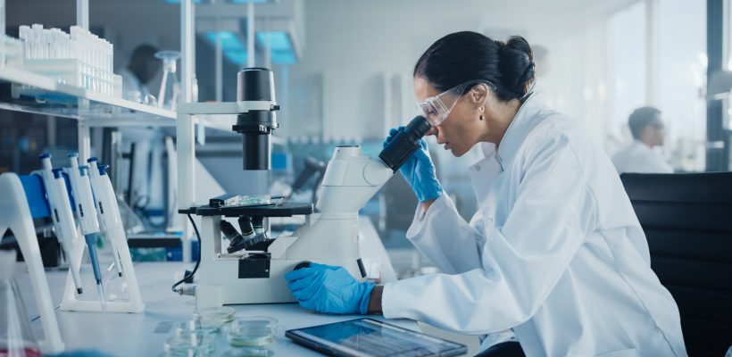 Medical,Development,Laboratory:,Caucasian,Female,Scientist,Looking,Under,Microscope,,Analyzes