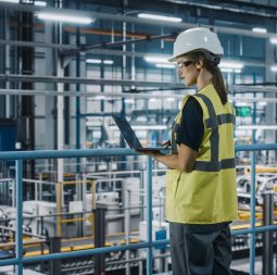 Female,Car,Factory,Engineer,In,High,Visibility,Vest,Using,Laptop