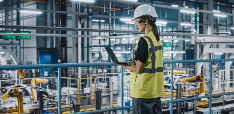 Female,Car,Factory,Engineer,In,High,Visibility,Vest,Using,Laptop